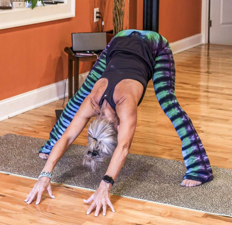 Sunrise Yoga Studio founder forward fold pose